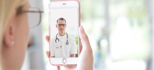 patient talks via her iphone to the doctor in a video consultation